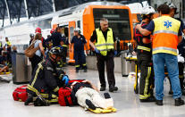 <p>An injured passenger is attended to on the platform of a train station in Barcelona, Spain, Friday, July 28, 2017. (Photo: Adrian Quiroga/AP) </p>