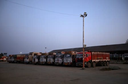 Supply trucks are seen parked inside empty Mustafa Memorial Fruit Mandi in Sopore