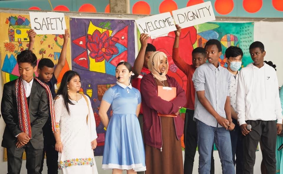 High school students from Grand Forks Public Schools perform a play for World Refugee Day on June 18, 2022 at the Town Square Farmers Market, marking the theme "Whoever. Wherever. Whenever. Everyone has the right to seek safety."