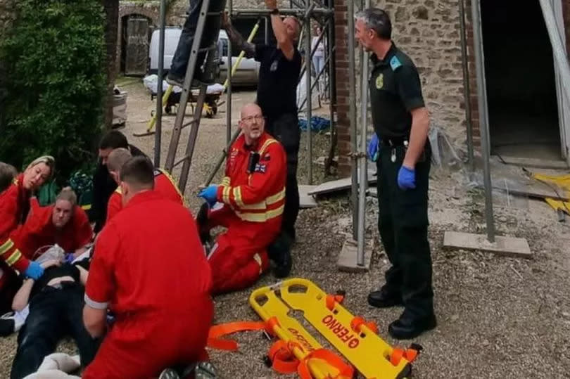 Paramedics and air ambulance staff attend to Niamh after she fell three stories from a scaffold