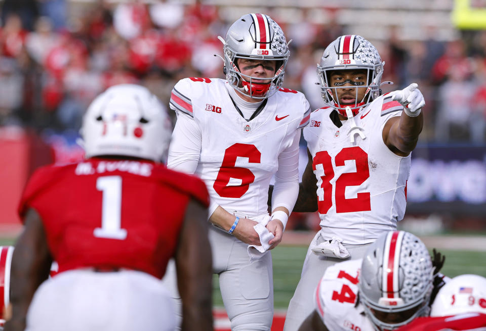 Ohio State quarterback Kyle McCord (6) talks to running back TreVeyon Henderson (32) before a play against Rutgers during the second half of a NCAA college football game, Saturday, Nov. 4, 2023, in Piscataway, N.J. Ohio State won 35-16. (AP Photo/Noah K. Murray)