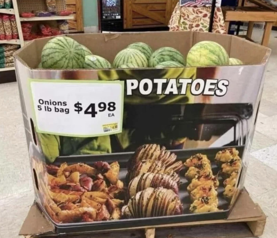 Bin with "Onions: 5 lb bag $5 each" and "Potatoes" written on it, with whole watermelons in it