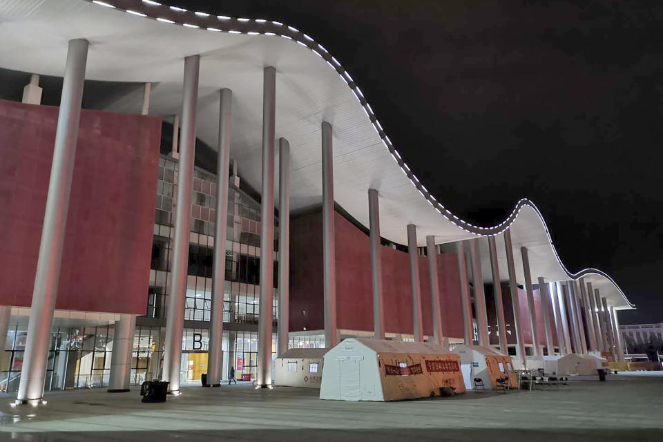 This Feb. 16, 2020, photo released by Zhang Junjian, shows the exterior of Wuhan Living Room Temporary Hospital which is converted from an exhibition center in Wuhan in central China's Hubei province. The hospital is the largest of 16 temporary hospitals set up in gyms and other locations to handle an overflow of patients and try to stem the spread of the coronavirus by separating them from the rest of the city's 11-million inhabitants. (Zhang Junjian via AP)
