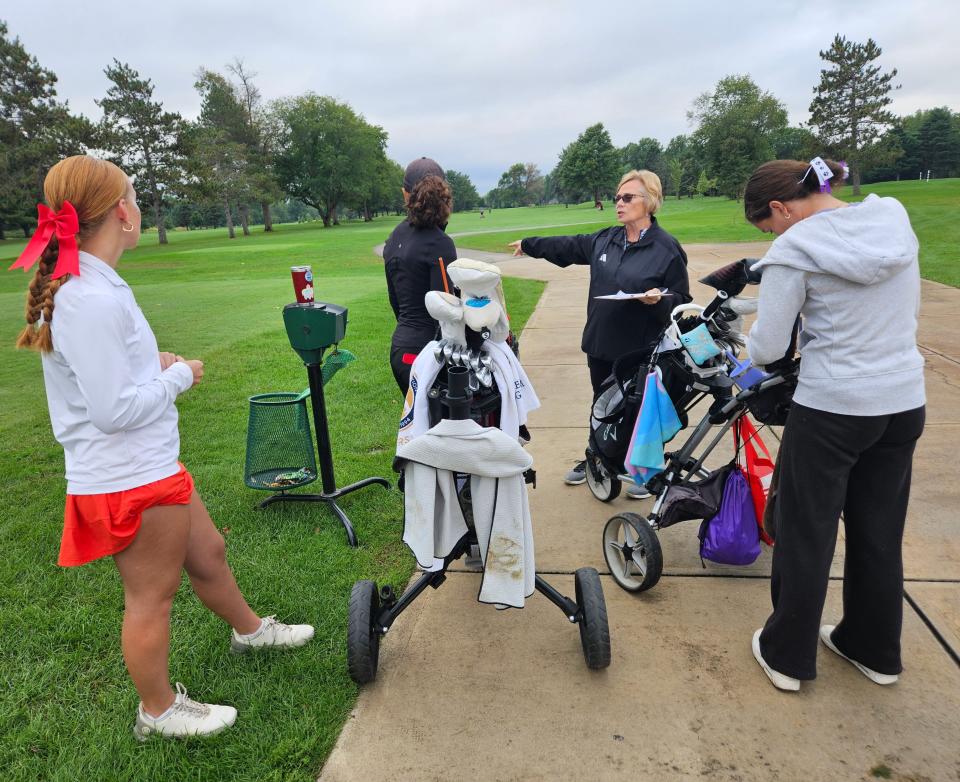 IHSAA regional championship girls golf organizer Sue Beam (center) gives pre match instructions to seniors Ellie Wilcoxson of West Lafayette (back), Addison Meadows of Southmont (left) and Maddie Campbell of Brownsburg (right) on Saturday, Sept. 28, 2024.