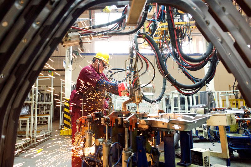 FILE PHOTO: Employee works on the production line at a factory of Chinese automaker JAC Motors in Weifang