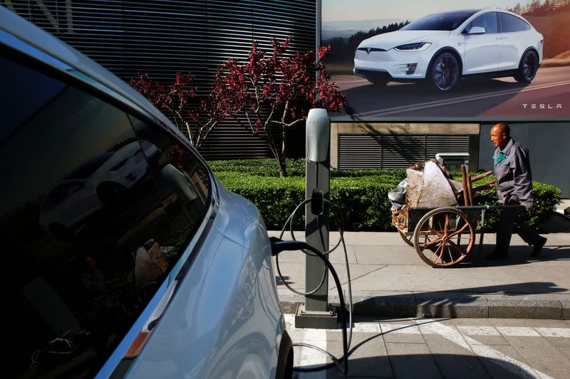 FILE PHOTO: A Tesla car being charged up at a charging station in Beijing