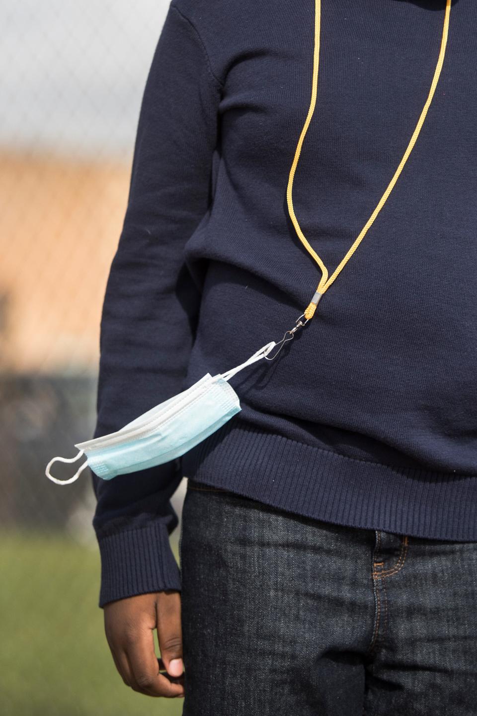 A mask hangs from a lanyard during gym class Tuesday, September 8, 2020, at Seaford Central Elementary School. 