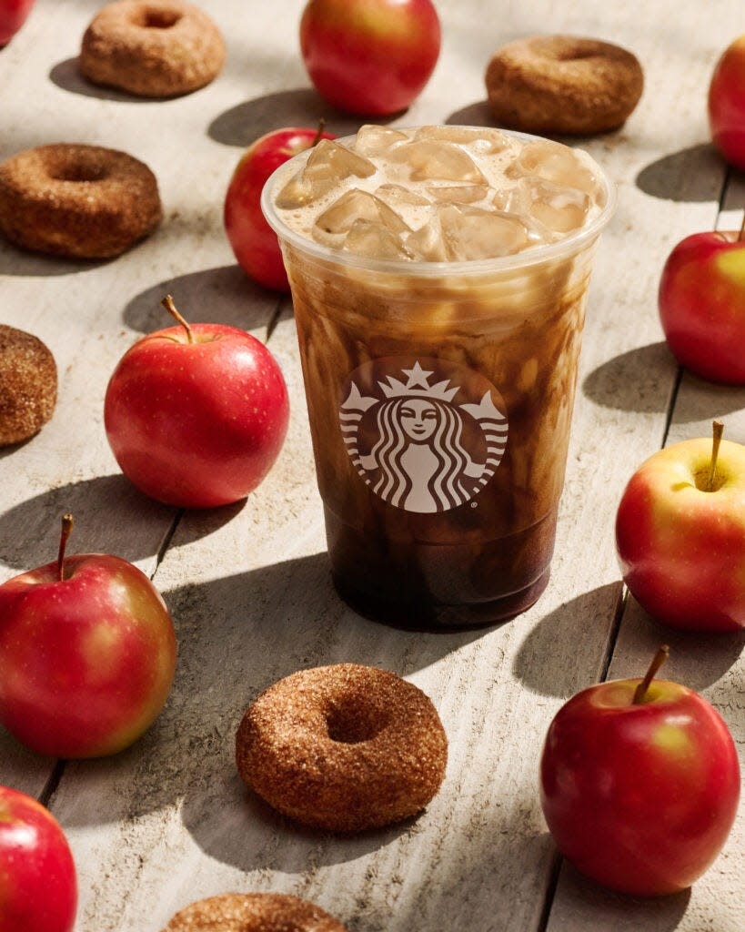 Starbucks Iced Apple Crisp Oatmilk Shaken Espresso is new to the fall 2023 menu. The drink is made with Blonde Espresso and notes of apple, cinnamon and brown sugar. The drink is topped with oatmilk.