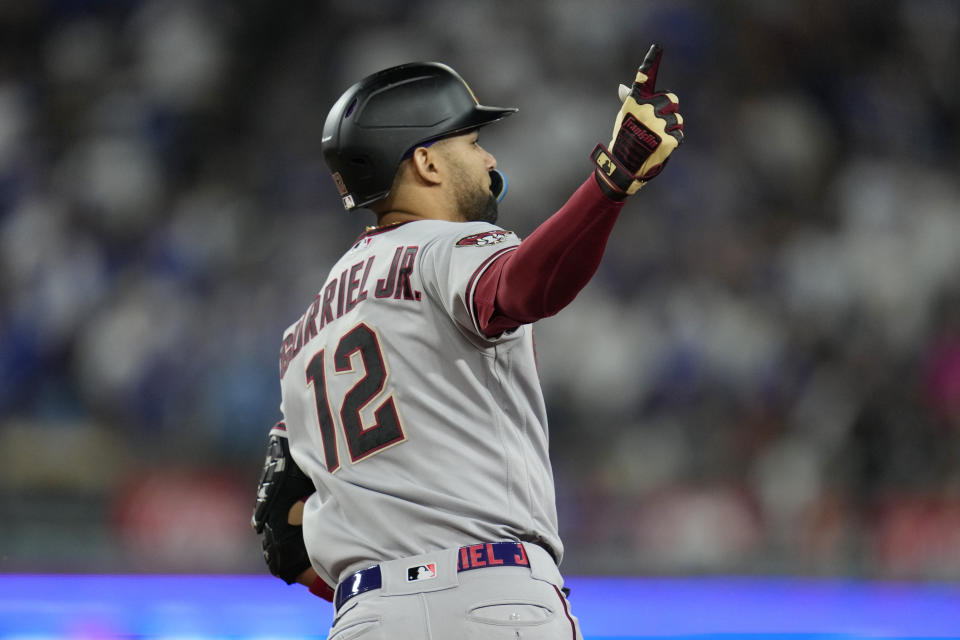 Arizona Diamondbacks' Lourdes Gurriel Jr. celebrates as he rounds first base after his solo home run during the sixth inning in Game 2 of a baseball NL Division Series against the Los Angeles Dodgers, Monday, Oct. 9, 2023, in Los Angeles. (AP Photo/Ashley Landis)