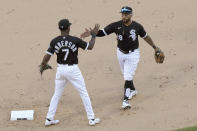 Chicago White Sox's Tim Anderson (7) and Leury Garcia celebrate the team's 7-3 win over the Cleveland Indians in a baseball game Saturday, May 1, 2021, in Chicago. Anderson and Garcia accounted for all the White Sox runs. (AP Photo/Charles Rex Arbogast)