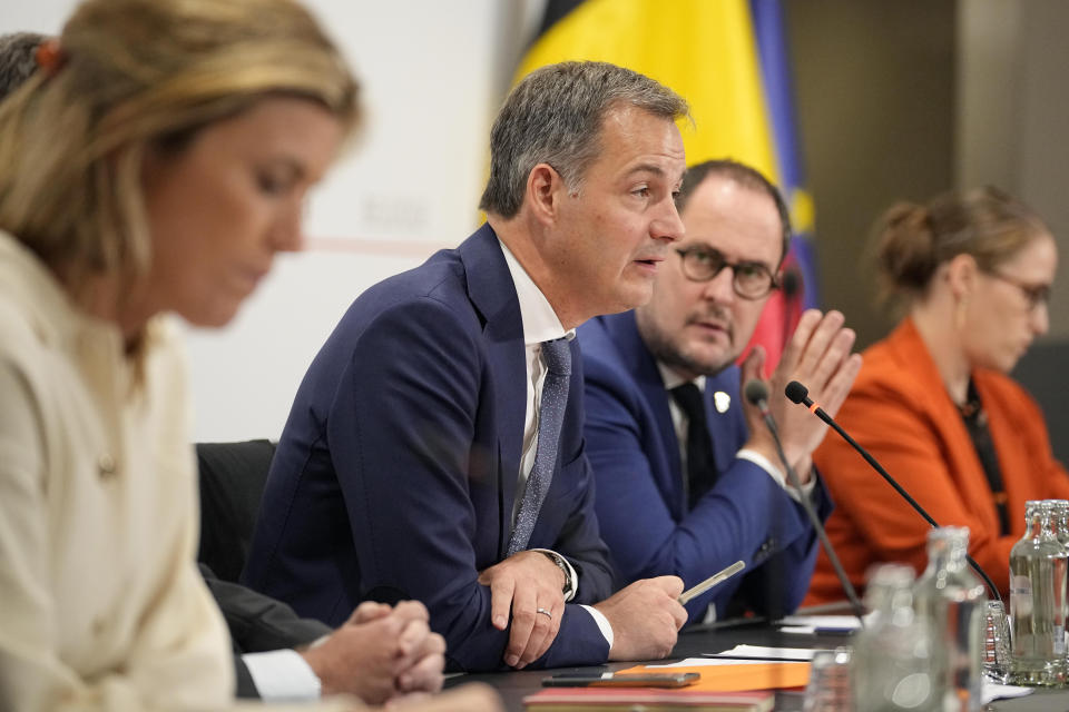 Belgian Prime Minister Alexander De Croo, centre, speaks during a press conference in Brussels Tuesday, Oct. 17, 2023, about the shooting of two Swedish soccer fans on Monday. Police in Belgium have shot dead a suspected Tunisian extremist, on Tuesday, accused of killing two Swedish soccer fans in a brazen attack on a Brussels street before disappearing into the night on Monday. (AP Photo/Martin Meissner)