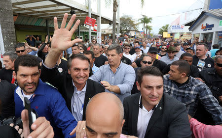 FILE PHOTO: Presidential candidate Jair Bolsonaro is greeted by supporters during an agribusiness fair in Esteio, Rio Grande do Sul state, Brazil August 29, 2018. REUTERS/Diego Vara/File photo