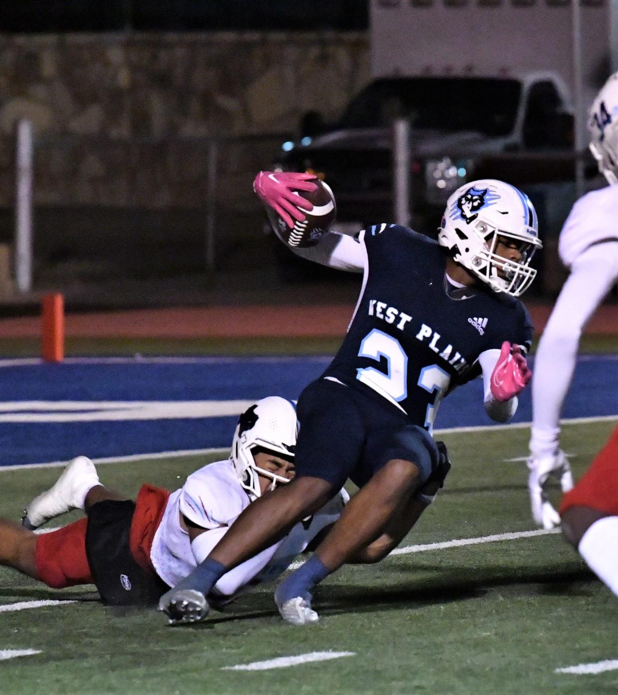 Hirschi's Javian Frazier tackles West Plains' King Tallant on Thursday, November 18, 2022 in Childress.