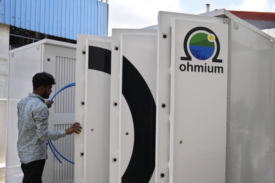 A technician conducts tests on the electrolyzer hydrogen module at the Ohmium manufacturing facility in Chikkaballapur, outside Bengaluru, India, Tuesday, April 25, 2023. The company announced Wednesday, April 26, it has raised $250 million to expand production of machines that can make clean hydrogen and displace fossil fuels. Ohmium's role is to make electrolyzers, the devices that take water and split it into hydrogen and oxygen. (AP Photo/Aijaz Rahi)