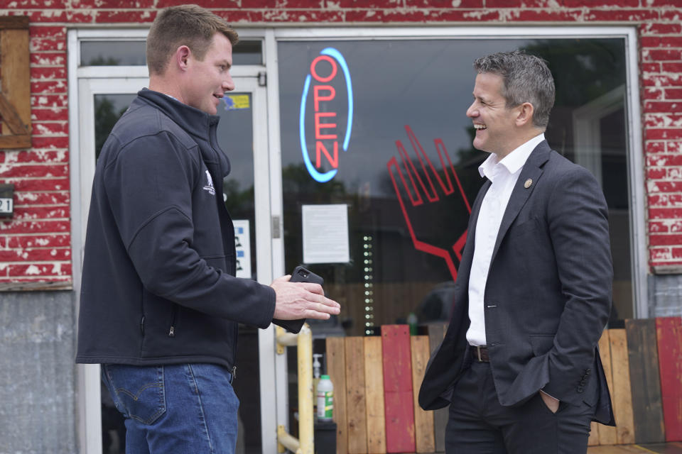 Rep. Adam Kinzinger, R-Ill., right, chats with Texas congressional candidate Michael Wood Tuesday, April 27, 2021, in Arlington, Texas. Wood is considered the anti-Trump Republican Texas congressional candidate that Kinzinger has endorsed in the May 1st special election for the 6th Congressional District. (AP Photo/LM Otero)