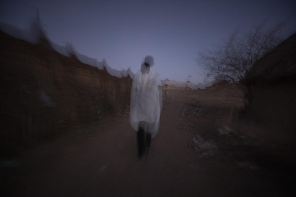 Tigrayan refugee Abraha Kinfe Gebremariam, 40, walks back to his shelter after praying at a church early in the morning in Hamdayet, eastern Sudan, near the border with Ethiopia, on March 21, 2021. As his family crossed the Tekeze River, leaving the Tigray bloodshed behind, he felt the burden of the previous month ease. “I was 100% sure the babies would grow up, that things would change from that moment,” he said. “Somehow my stress melted away. There were no more fears for our lives.” (AP Photo/Nariman El-Mofty)