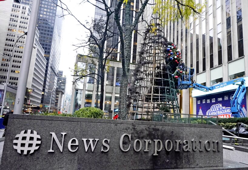 A worker disassembles a Christmas tree outside Fox News headquarters, in New York, Wednesday, Dec. 8, 2021. Police say a man is facing charges including arson for setting fire to a 50-foot Christmas tree in front of Fox News headquarters in midtown Manhattan. The tree outside of the News Corp. building that houses Fox News, The Wall Street Journal and the New York Post caught fire early Wednesday. (AP Photo/Richard Drew)