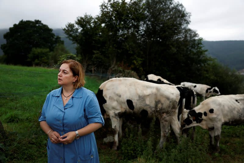 Monserrat Fernandez, mayor of the Asturian town of Tineo, stands next to her cattle in Tineo