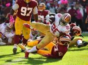 Oct 15, 2017; Landover, MD, USA; San Francisco 49ers running back Carlos Hyde (28) scores a touchdown over Washington Redskins cornerback Quinton Dunbar (47) during the second half at FedEx Field. Mandatory Credit: Brad Mills-USA TODAY Sports