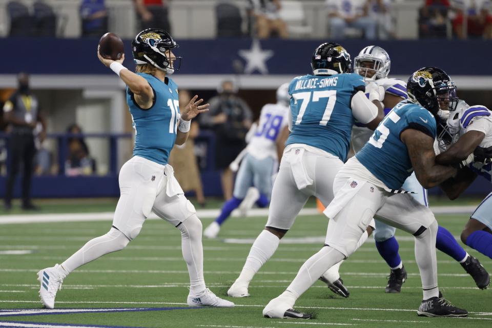 Jacksonville Jaguars quarterback Trevor Lawrence (16) throws a pass under protection from Jacksonville Jaguars' Tre'Vour Wallace-Simms (77) and Jawaan Taylor, right, in the first half of a preseason NFL football game against the Dallas Cowboys in Arlington, Texas, Sunday, Aug. 29, 2021. (AP Photo/Ron Jenkins)