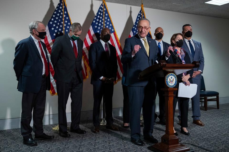 Senate Majority Leader Chuck Schumer, D-N.Y., speaks to reporters alongside, from left, Sen. Tim Kaine, D-Va., Sen. Jeff Merkley, D-Ore., Sen. Raphael Warnock, D-Ga., Sen. Cory Booker, D-N.J., Sen. Amy Klobuchar, D-Minn., and Sen. Alex Padilla, D-Calif., during a press conference regarding the Democratic party's shift to focus on voting rights at the Capitol in Washington, Tuesday, Jan. 18, 2022. (AP Photo/Amanda Andrade-Rhoades) ORG XMIT: DCAR130