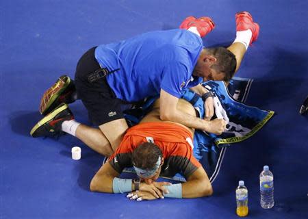 Rafael Nadal of Spain receives treatment during his men's singles final match against Stanislas Wawrinka of Switzerland at the Australian Open 2014 tennis tournament in Melbourne January 26, 2014. REUTERS/David Gray