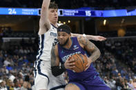 Charlotte Hornets forward Miles Bridges drives against Memphis Grizzlies forward Jake LaRavia (3) during the first half of an NBA basketball game Wednesday, March 13, 2024, in Memphis, Tenn. (AP Photo/Brandon Dill)