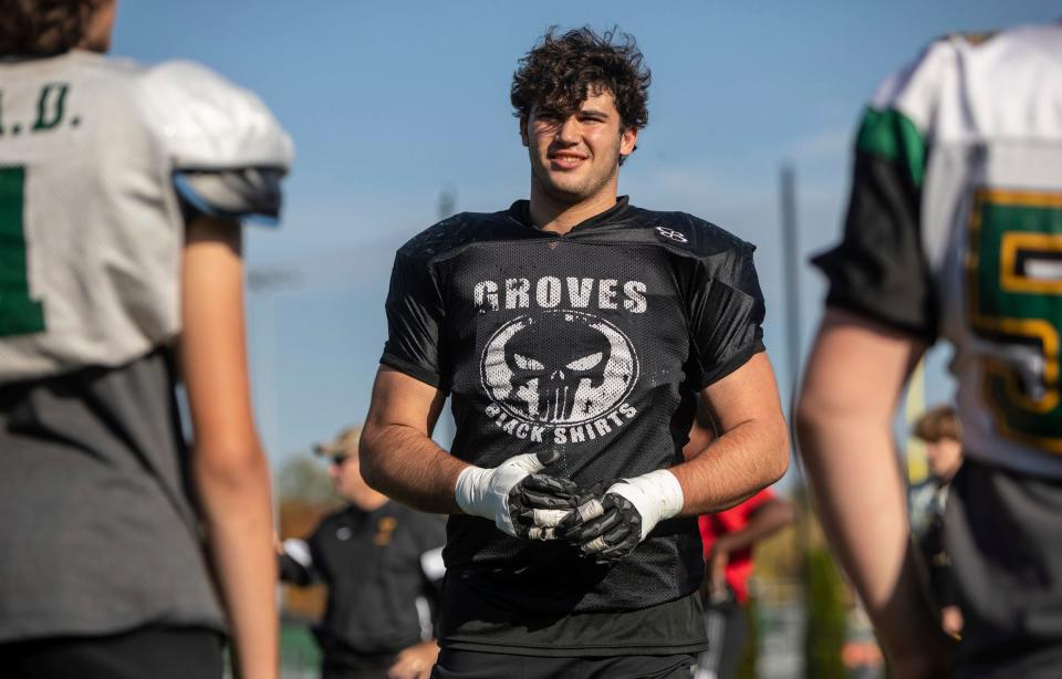 Avery Gach, 17, a junior at Birmingham Groves High School, stands alongside his teammates during a football practice in Beverly Hills on Tuesday, Oct. 24, 2023.