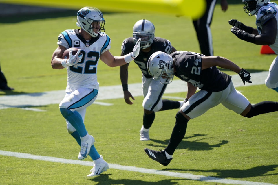 Carolina Panthers running back Christian McCaffrey scores ahead of Las Vegas Raiders safety Johnathan Abram during the second half of an NFL football game Sunday, Sept. 13, 2020, in Charlotte, N.C. (AP Photo/Brian Blanco)