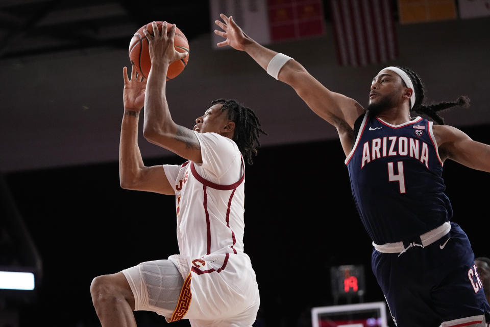 Southern California guard Boogie Ellis, left, shoots as Arizona guard Kylan Boswell defends during the second half of an NCAA college basketball game Thursday, March 2, 2023, in Los Angeles. (AP Photo/Mark J. Terrill)