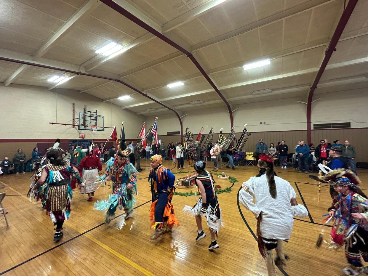 Dancers follow behind the flag carriers during the grand entry of the Sault Tribe's 2022 Honoring Our Veterans Powwow on Nov. 12 at the Kinross Rec Center.