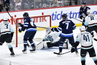 Winnipeg Jets' Tyler Toffoli (73) scores on Seattle Kraken goaltender Philipp Grubauer (31) during the third period of an NHL hockey game in Winnipeg, Manitoba on Tuesday April 16, 2024. (Fred Greenslade/The Canadian Press via AP)