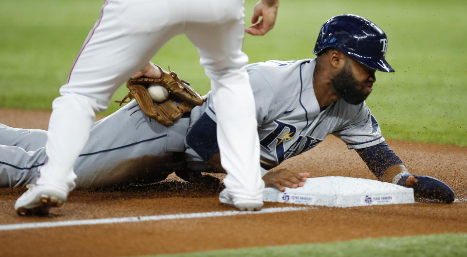 Tampa Bay Rays' Manuel Margot (13) is safe as Texas Rangers third baseman Charlie Culberson (2) attempts the tag during the first inning of a baseball game, Saturday, June 5, 2021, in Arlington, Texas. (AP Photo/Brandon Wade)