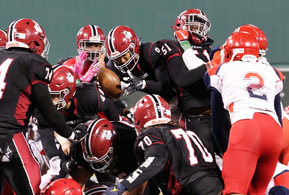 Brockton's Oluwakoleade Osinubi scores a touchdown during a game versus Bridgewater-Raynham at Fenway Park on Wednesday, Nov. 23, 2022.      