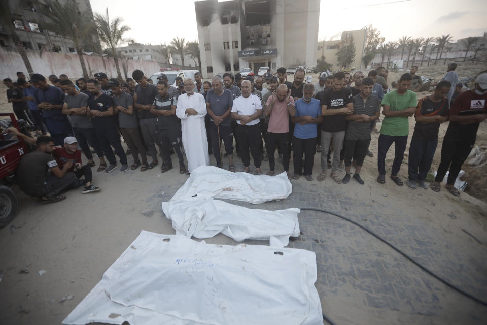 Palestinians pray for victims of Israeli bombardment before their burial in Khan Younis, southern Gaza Strip, Friday, June 21, 2024. (AP Photo /Jehad Alshrafi)