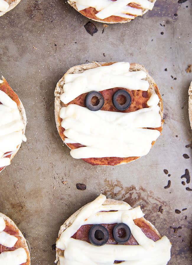 <p>Make these "mummified" English muffin pizzas in a matter of minutes. </p><p>Get the <a href="http://lmld.org/2015/10/13/mummy-mini-pizzas/" rel="nofollow noopener" target="_blank" data-ylk="slk:Mummy Mini Pizzas recipe;elm:context_link;itc:0;sec:content-canvas" class="link "><strong>Mummy Mini Pizzas recipe</strong></a> from Like Mother, Like Daughter. </p>