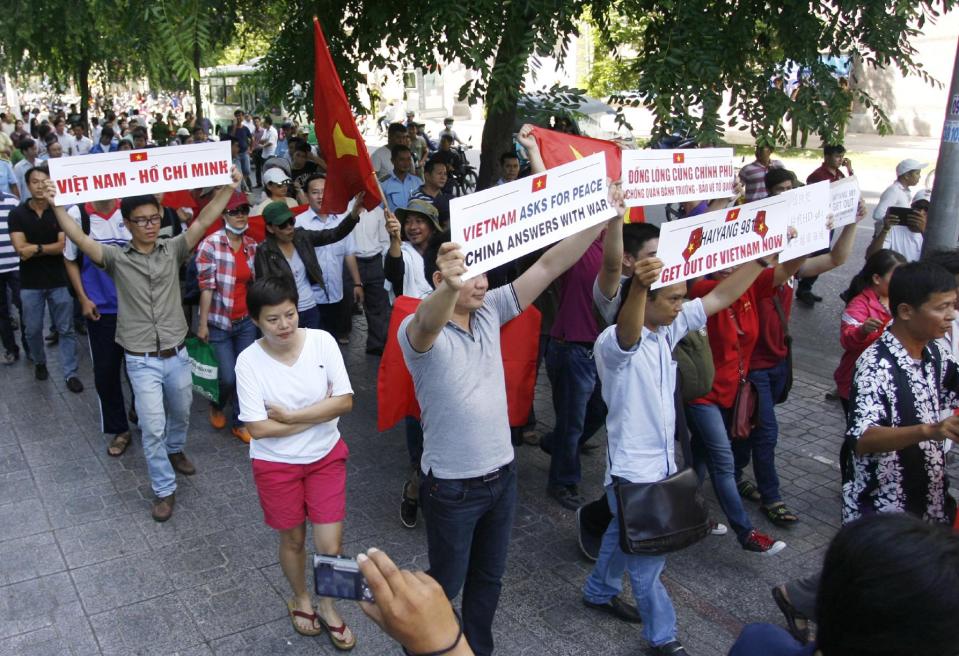 Vietnamese protesters hold up placards during a protest rally against China outside the Chinese Consulate in Ho Chi Minh City, Vietnam, Saturday, May 10, 2014. Around 100 people gathered and protested China’s deployment of an oil rig in the disputed South China Sea, in the country's commercial capital. Vietnamese anger toward China is running at its highest level in years after Beijing deployed the oil rig in the disputed water. (AP Photo)