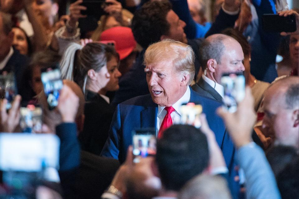 Former President Donald Trump greets supporters as he arrives to a press event at Mar-a-Lago on Tuesday in Palm Beach after being arraigned earlier in the day in New York City.