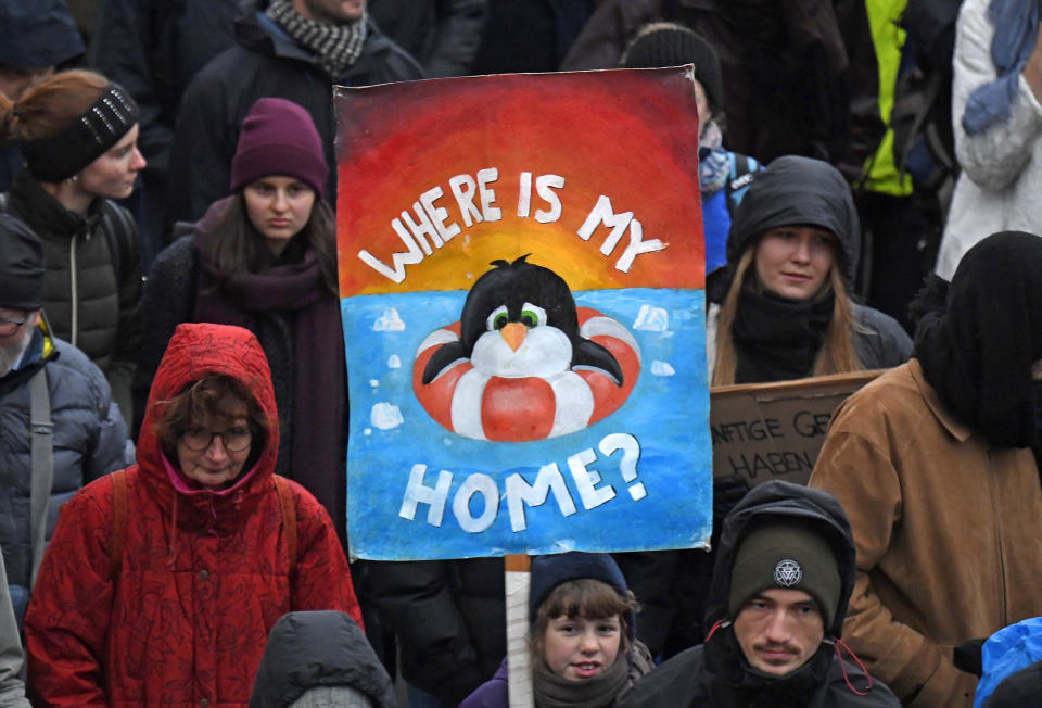 A demonstrator holds a poster during a protest climate strike ralley of the 'Friday For Future Movement' in Leipzig, Germany, Friday, Nov. 29, 2019. Cities all over the world have strikes and demonstrations for the climate during this ClimateActionDay. (AP Photo/Jens Meyer)