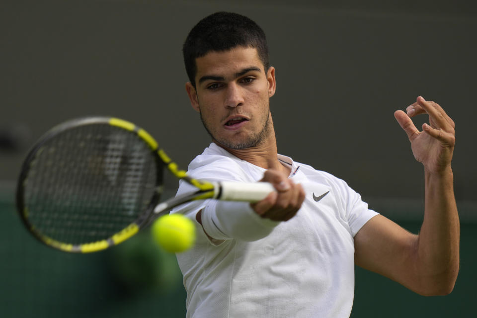 Spain's Carlos Alcaraz returns the ball to Germany's Oscar Otte in a men's singles match on day five of the Wimbledon tennis championships in London, Friday, July 1, 2022. (AP Photo/Alastair Grant)