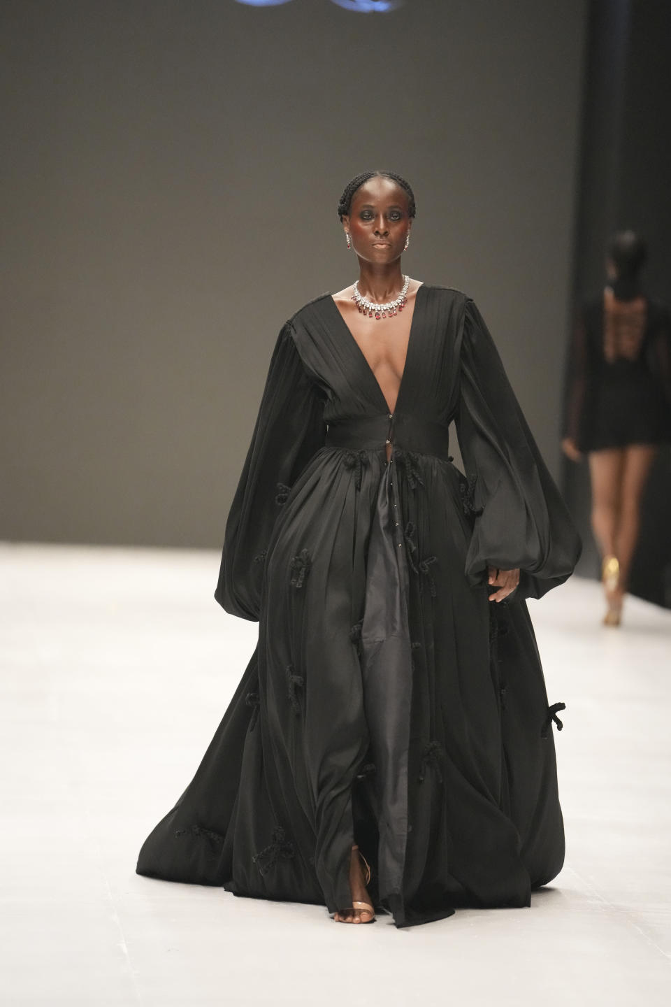 A model wears a creation by Lulla House during the Lagos Fashion Week in Lagos, Nigeria, Thursday, Oct. 26, 2023. Africa's fashion industry is rapidly growing to meet local and international demands but a lack of adequate investment still limits its full potential, UNESCO said Thursday in its new report released at this year's Lagos Fashion Week show. (AP Photo/Sunday Alamba)