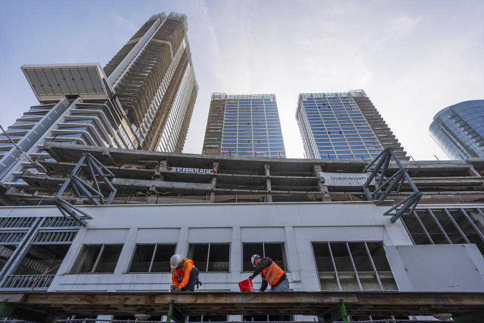 Crews begin removing scaffolding protecting a temporary walkway that officials say said has helped helped trespassers enter an unfinished complex of downtown Los Angeles that have recently been vandalized with graffiti and used for dangerous social media stunts in Los Angeles Friday, Feb. 16, 2024. (AP Photo/Damian Dovarganes)