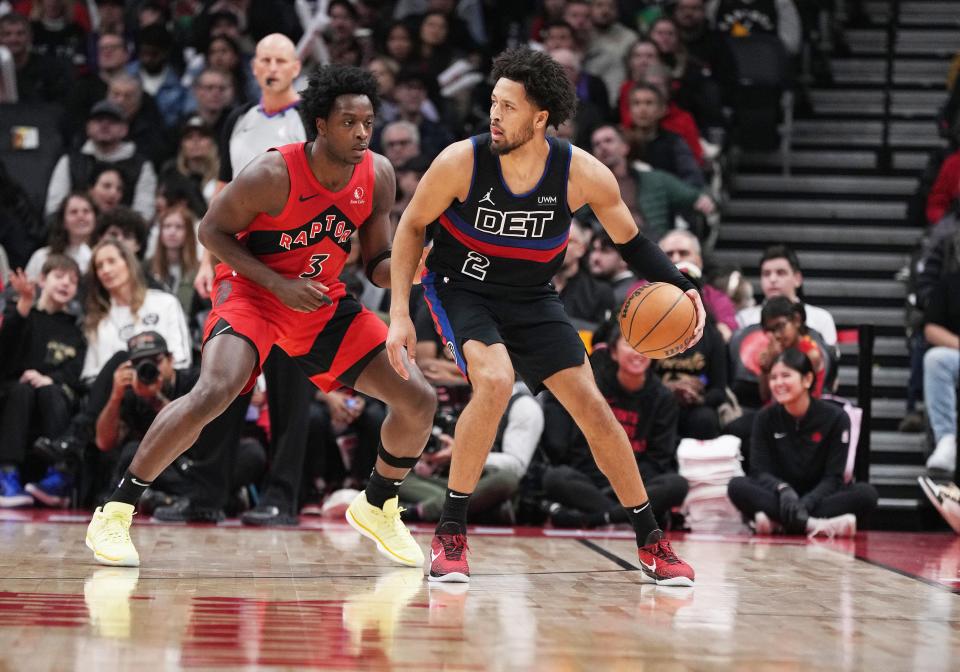 Pistons guard Cade Cunningham controls the ball as Raptors forward O.G. Anunoby defends during the second quarter on Sunday, Nov. 19, 2023, in Toronto.