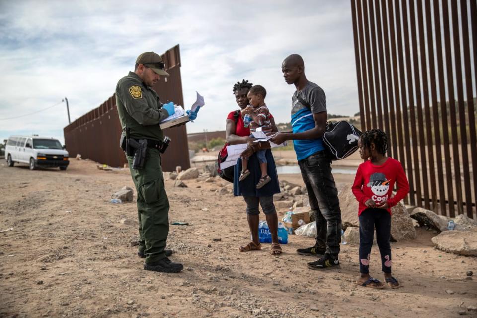 YUMA, ARIZONA – DECEMBER 07: An immigrant family from Haiti is taken into custody by a U.S. Border Patrol agent at the U.S.-Mexico border on December 07, 2021 in Yuma, Arizona.(Photo by John Moore/Getty Images)