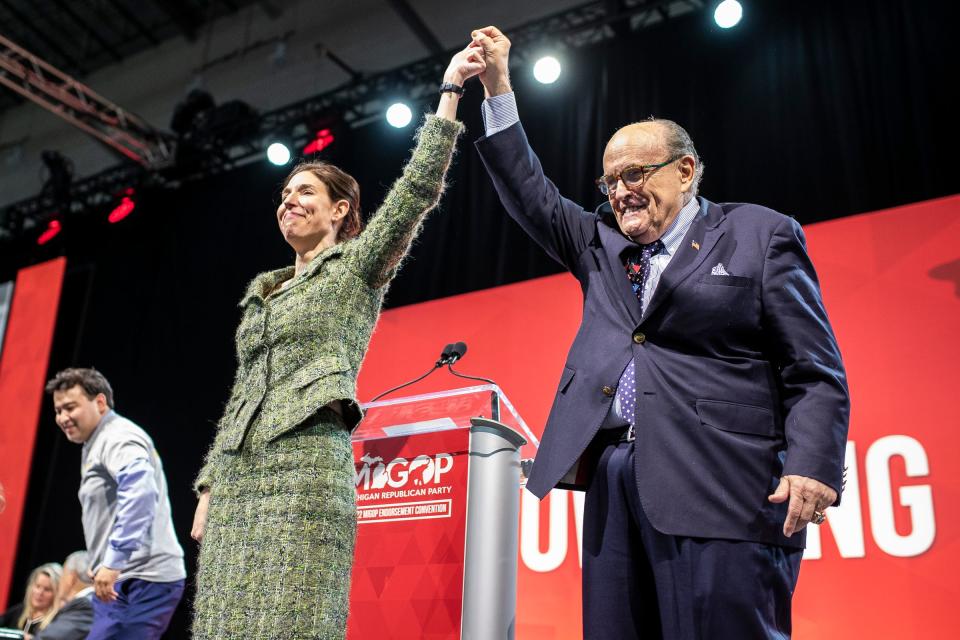 U-M regent candidate Lena Epstein and her family with Rudy Giuliani wave at supporters during the MIGOP State Convention at the DeVos Place in Grand Rapids on April 23, 2022.