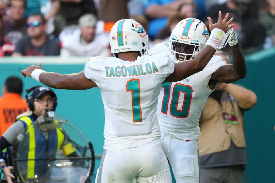 Tyreek Hill and Tua Tagovailoa celebrate during a game against the Browns.