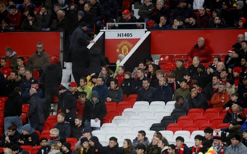 Manchester United fans walk out of the stadium in disgust as their team loses to Burnley - Credit: reuters