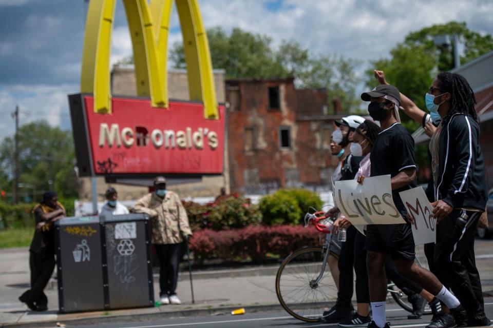 GettyImages 1216832772 PHILADELPHIA, PA - JUNE 01: protesters march with three placards stating "BLACK Lives Matter" past a vandalized McDonald's restaurant on June 1, 2020 in Philadelphia, Pennsylvania. Demonstrations have erupted all across the country in response George Floyd's death in Minneapolis, Minnesota while in police custody a week ago. (Photo by Mark Makela/Getty Images)