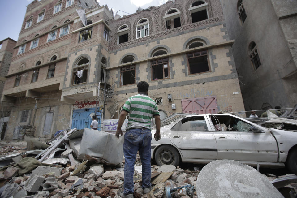 People inspect the site of an airstrike by Saudi-led coalition in Sanaa, Yemen, Thursday, May, 16, 2019. Yemen's human rights minister says heavy fighting is underway in the country's south as rebel Houthis push to gain more territory from government forces and their allies. The clashes come as the Saudi-led coalition carried out airstrikes on the capital, Sanaa, earlier on Thursday, targeting the Houthis and killing at least three civilians. (AP Photo/Hani Mohammed)