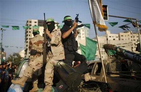 Palestinian Hamas militants take part in a military parade marking the first anniversary of the eight-day conflict with Israel, in Gaza City November 14, 2013. REUTERS/Mohammed Salem